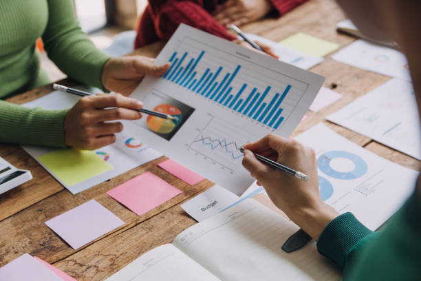 istock Financial analysts analyze business financial reports on a digital tablet planning investment project during a discussion at a meeting of corporate showing the results of their successful teamwork. 1868911357