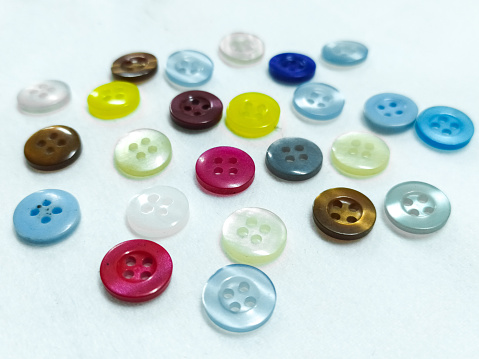 Colorful shirt buttons in white isolation.
