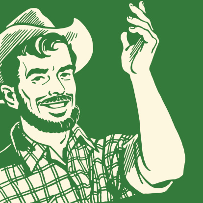 A farmer with a beard making hand gestures
