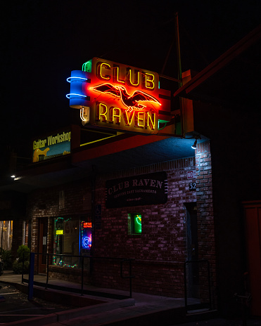 Club Raven, bar located on J St. since 1946. It had a cameo appearance in “Lady Bird,”  Night picture of outside of blub with their distinctive neon sign.