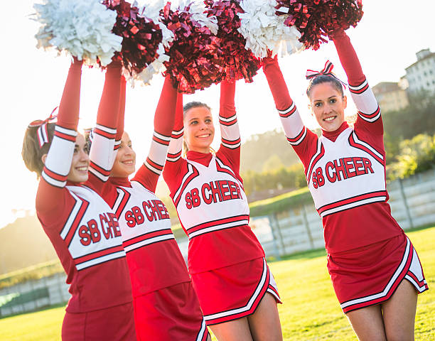 istock Group of Cheerleaders with Raised Pompom 186903640