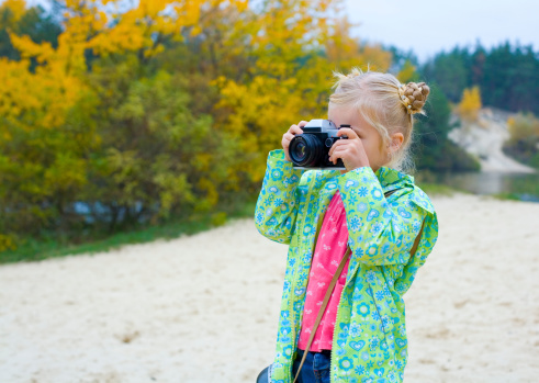 Beautiful five-year-old girl with camera