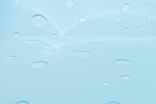 istock Defocus blurred transparent blue colored clear calm water surface texture with splashes and bubbles. Trendy abstract nature background. Water waves in sunlight with copy space. Blue watercolor shining 1869055100