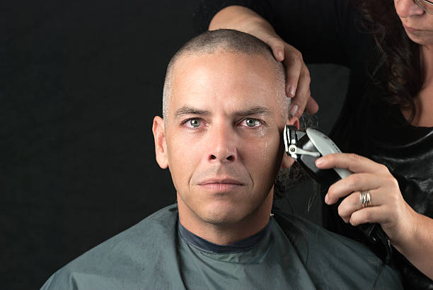 istock Mourning Man Gets Head Shaved For Fundraiser, Looks To Camera 186907389