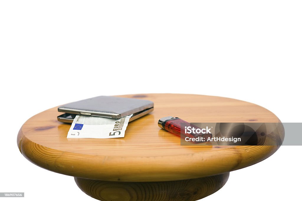 smoking money a cigarette case with a five-euro bill and a lighter on a wooden stool Chair Stock Photo