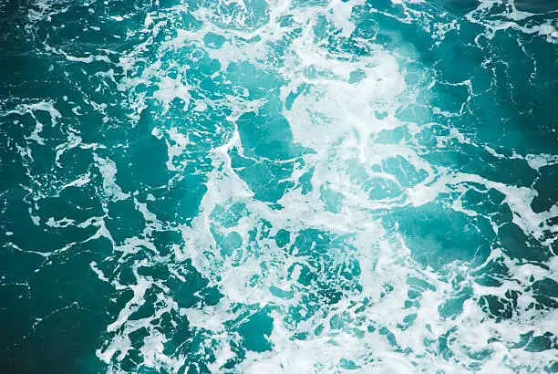 Wave breaking against cliff in Cinque Terre, Italy, view from above