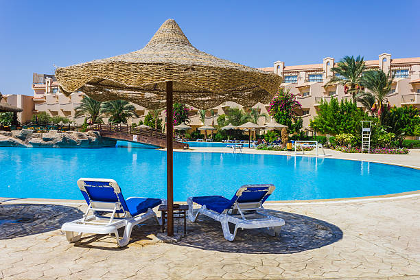 istock the pool, beach umbrellas 186911995