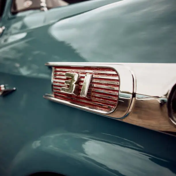 Photo of Close up of classic car chrome logo side view