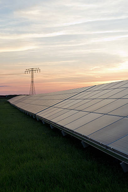 solar energy and highvoltage pylon stock photo