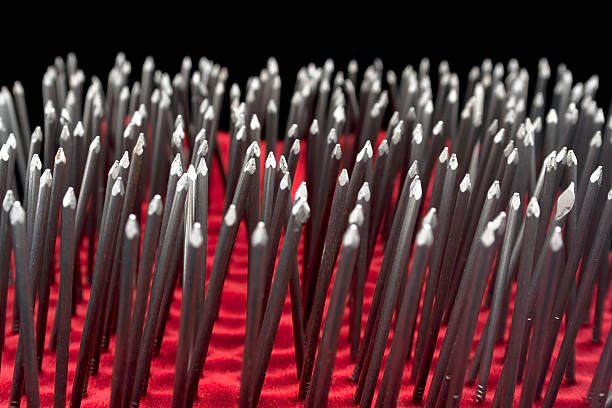 Bunch of nails Bunch of nails on a black background - Selective focus - Isolated on black bed of nails stock pictures, royalty-free photos & images