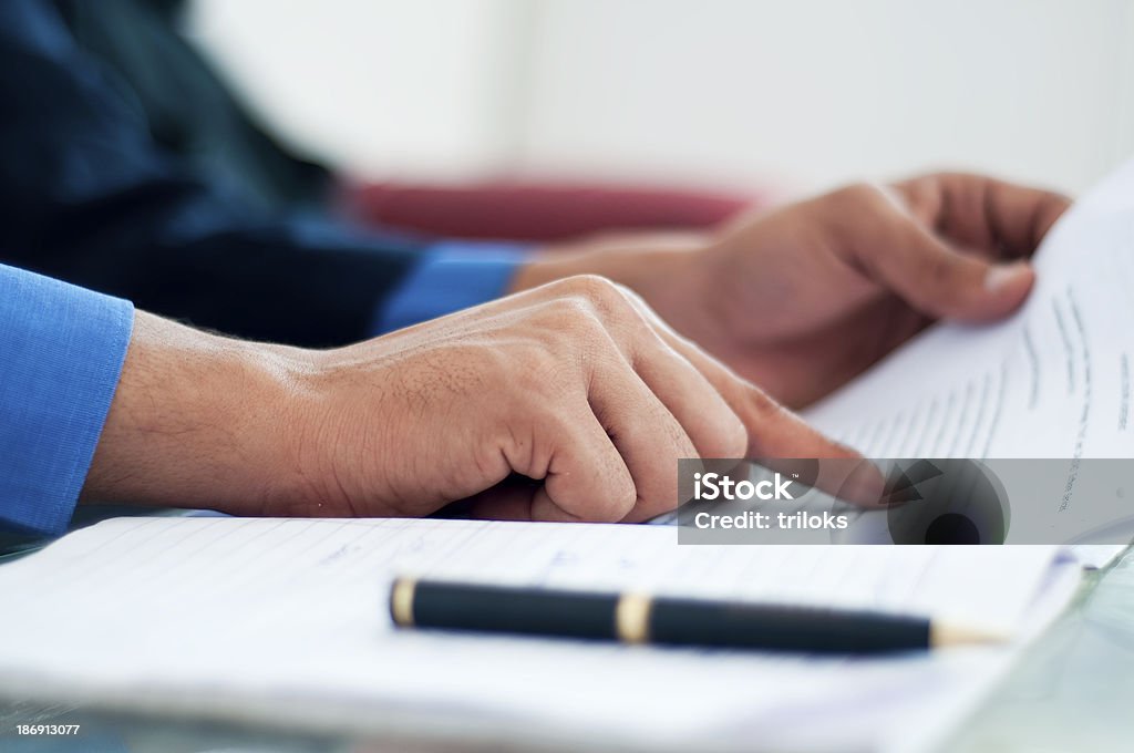 Close up of hands verifying business document Businessman verifying the documents Contract Stock Photo