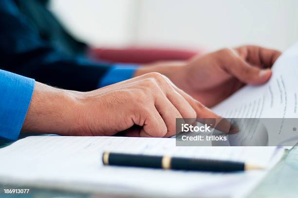 Close Up Of Hands Verifying Business Document Stock Photo - Download Image Now - Contract, Identity, Verification