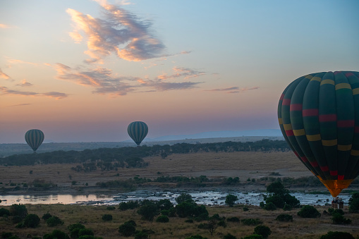 the Mara from above – the Mara River seen from above aboard a hot air balloon with other hot air balloons around, with beautiful morning light at sunrise - Serengeti – Tanzania