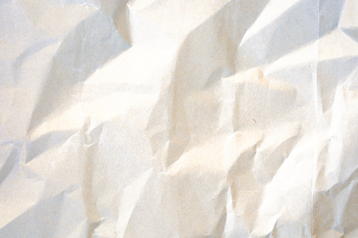 Crumpled white paper abstract shape background with space paper for text