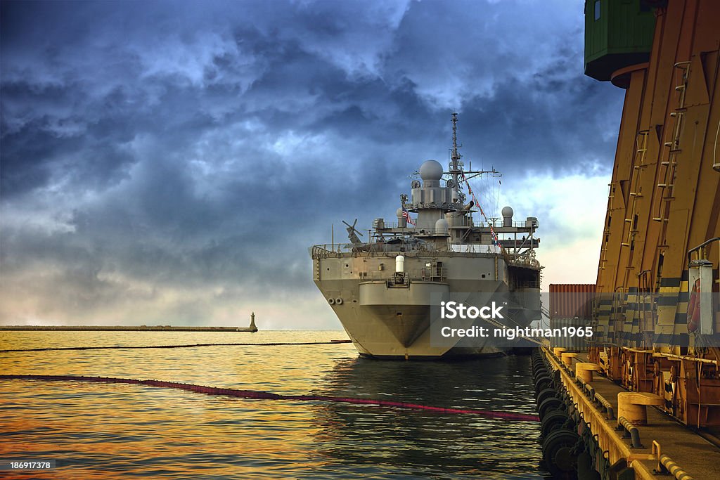 Warship in port Warship in the port of dramatic scenery. Armed Forces Stock Photo