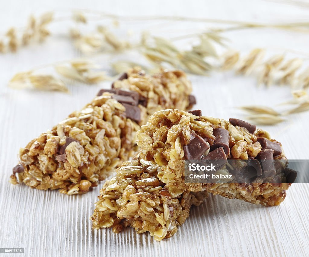 Granola bars Granola bars with chocolate on white wooden background Protein Bar Stock Photo
