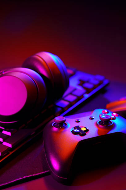 istock Headphones, joystick and computer keyboard on black table 1869190772
