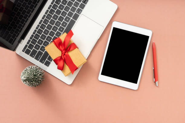 istock Pink office desk table with Laptop, Digital tablet and christmas decorations. 1869191841
