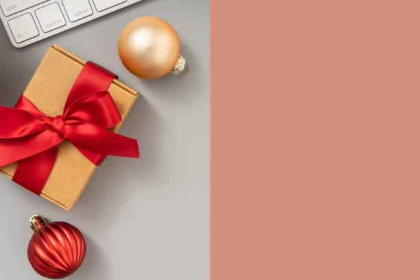 istock Christmas and New Year background with Computer keyboard, Christmas ball and Gift Box, Top view. 1869192404