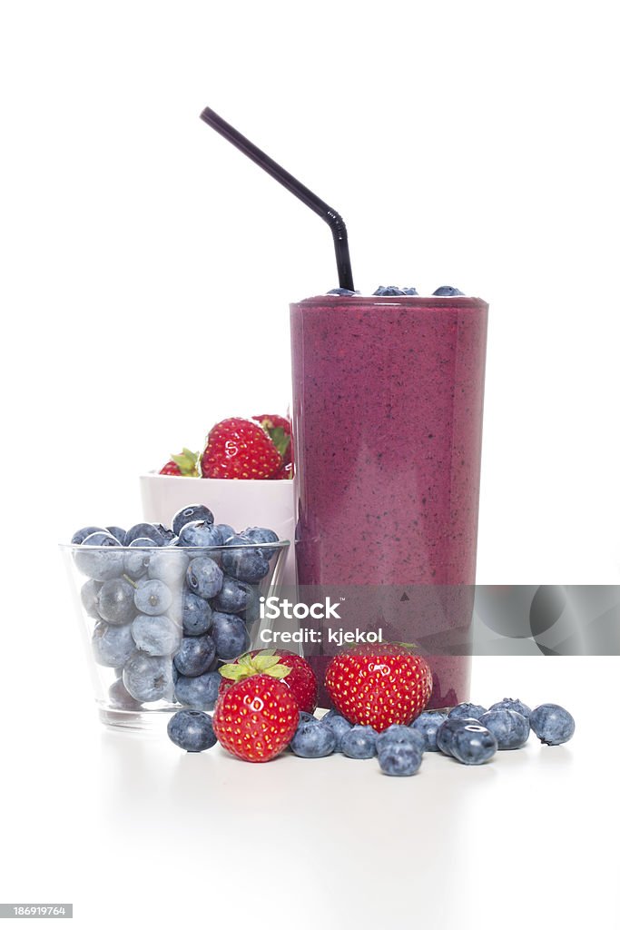 Fresh organic berry smoothie One glass of fresh organic smoothie with straw and blue berries. Berry Stock Photo