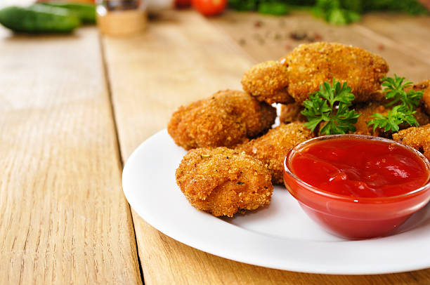 istock Fried chicken nuggets on the plate onto wooden table 186920054