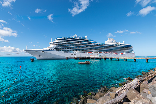 A ship waits on the horizon on a beautiful beach in the Caribbean.