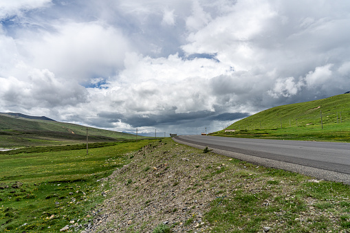 Grassland and highways on the plateau under cloudy weather