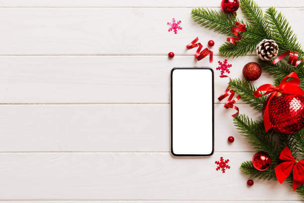 istock Digital phone mock up with rustic Christmas decorations for app presentation top view with empty space for you design. Christmas online shopping concept. Tablet with copy space on colored background 1869214499