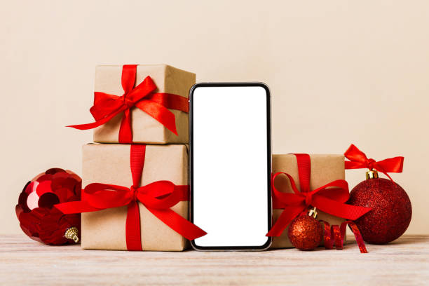 istock Digital phone mock up with rustic Christmas decorations for app presentation with empty space for you design. Christmas online shopping concept. Tablet with copy space on colored background 1869215086