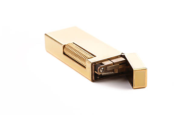 Elegant golden gas lighter. Isolated on a white background.