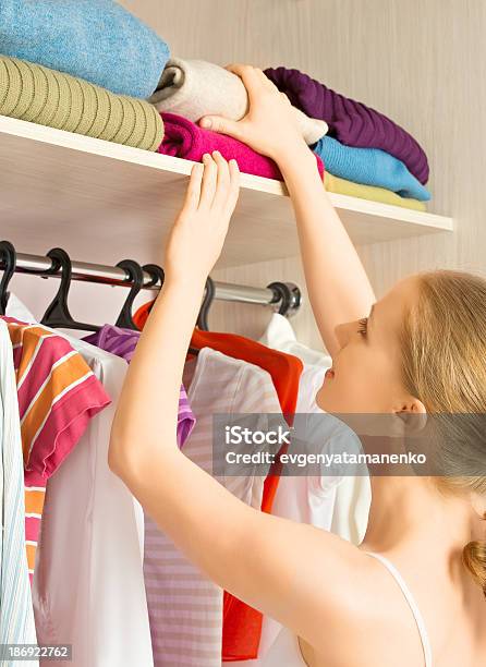 Woman Chooses Clothes In The Wardrobe Closet At Home Stock Photo - Download Image Now