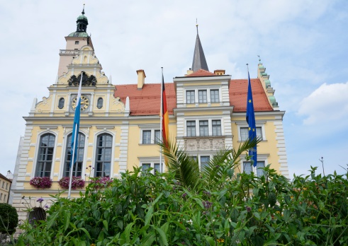 A public park and the town hall tower towering over tenement houses in Opole