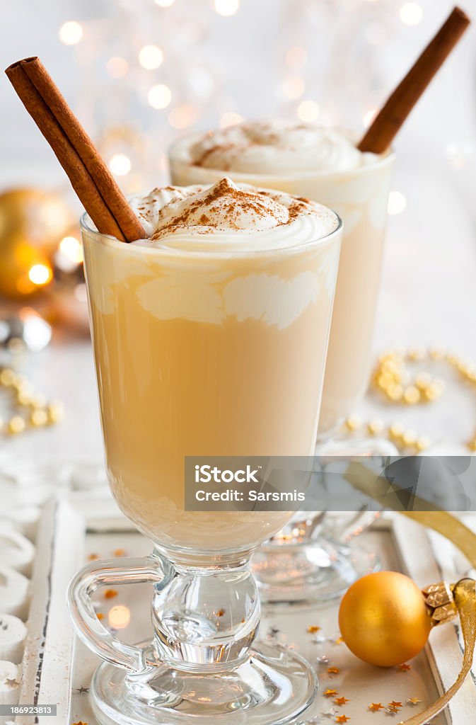 Glasses of egg nog with cinnamon sticks Egg Nog with Cinnamon Sticks Alcohol - Drink Stock Photo