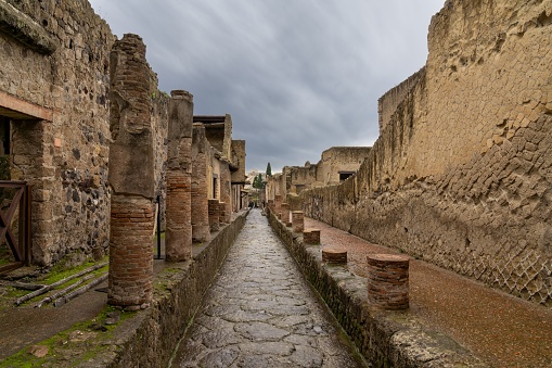 Ercolano, Italy - 25 November, 2023: typical city street and houses in the ancient Roman town of Herculaneum