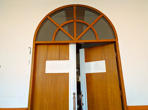 The church door is marked with a cross as a symbol of Catholic strength