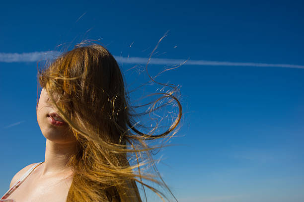 istock woman face  a flowing hair 186924953