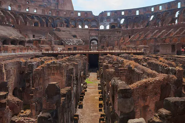 A ground-level view of the Colosseum in Rome, looking down at the corridor of former basement and its chambers