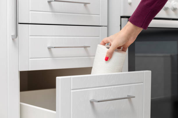 istock woman taking out paper towel from kitchen drawer. 1869257915