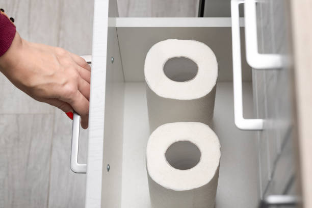 istock woman taking out paper towel from kitchen drawer. 1869258954