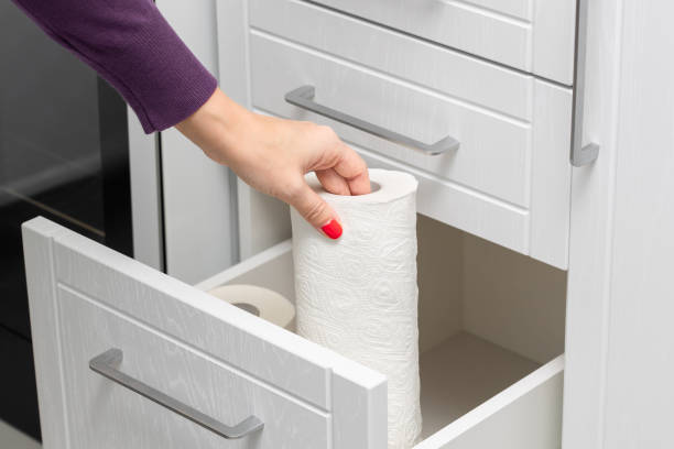 istock woman taking out paper towel from kitchen drawer. 1869258959