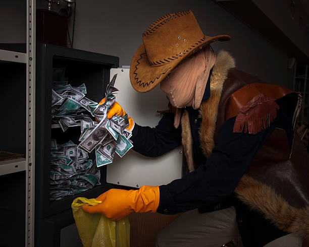 istock thief steals money from the safe 186928277