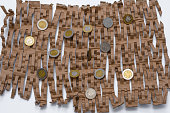 The coins lie on a paper filler for courier parcels