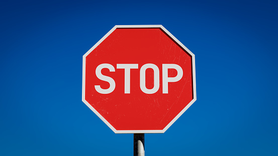 Stop sign in front of a warehouse