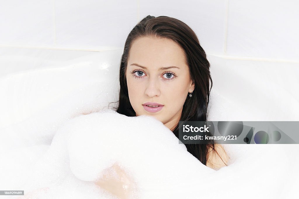 Pretty brunette Attractive brunette woman irelaxing in bath. Adult Stock Photo