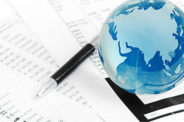 istock Glass globe and pen on finance 186929496