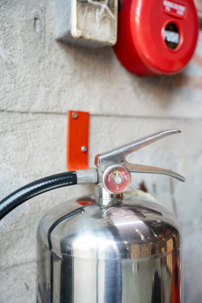 istock Stainless steel fire extinguisher for water hangs in document storage warehouse. 1869301297