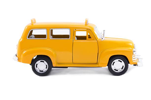 istock A yellow vintage two door car in a white background  186930461