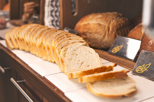 Organic sliced bread on a shelf in a bakery.