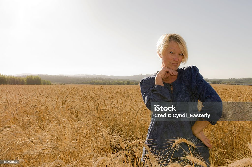 Flirty Senior Woman posing in a field Mature woman posing for a portrait with copy space 50-59 Years Stock Photo