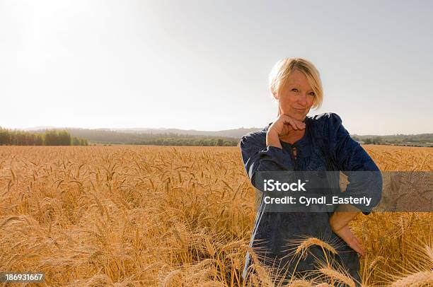Flirty Senior Woman Posing In A Field Stock Photo - Download Image Now - 50-59 Years, 60-64 Years, 60-69 Years